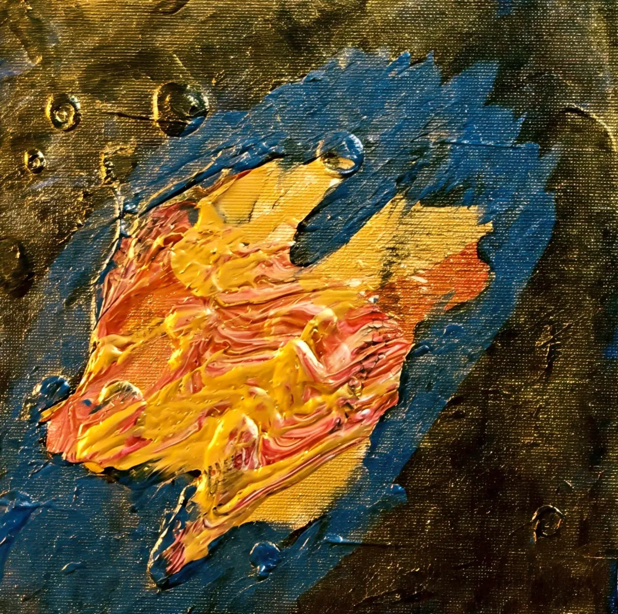 An impasto palette-knife painting: a burst of yellow, gold, orange, and red paint shaped like a flame or a bird in flight, on a dark blue-black ground.