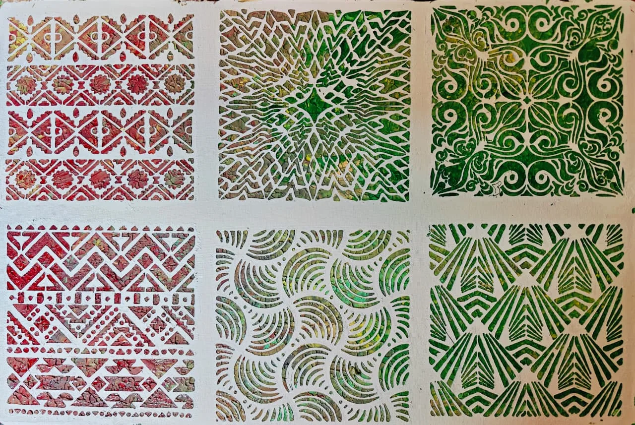 A sheet of six stencilled pattern squares: tribal bands and chevrons in red, a lattice and fans in olive, scrollwork and waves in green, on white.
